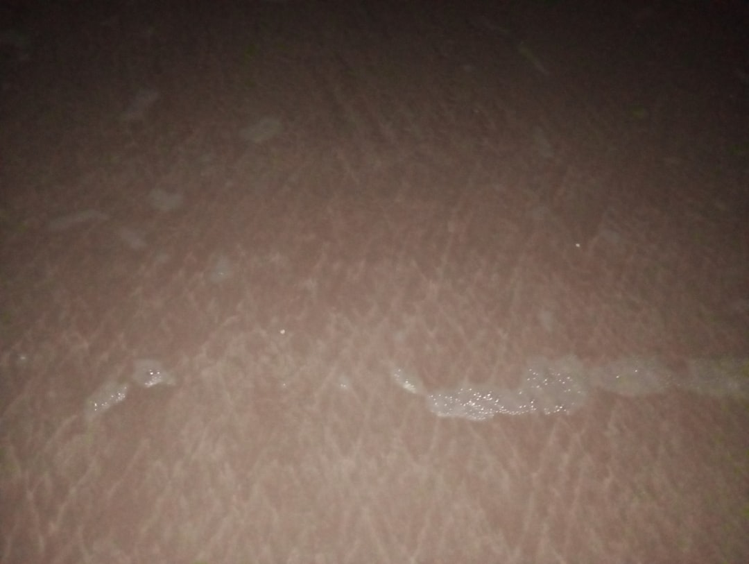 a close up of a white object on a brown surface