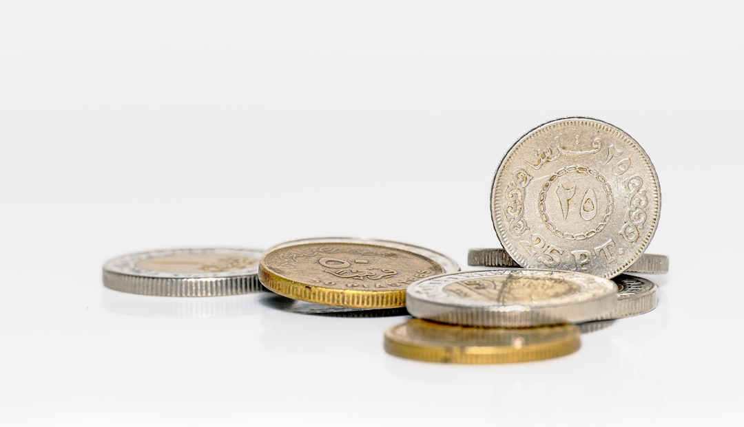 A pile of coins sitting on top of a white table