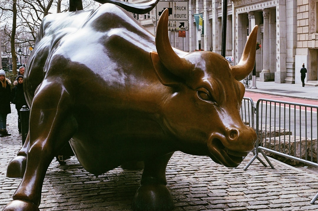 A statue of a bull on a city street