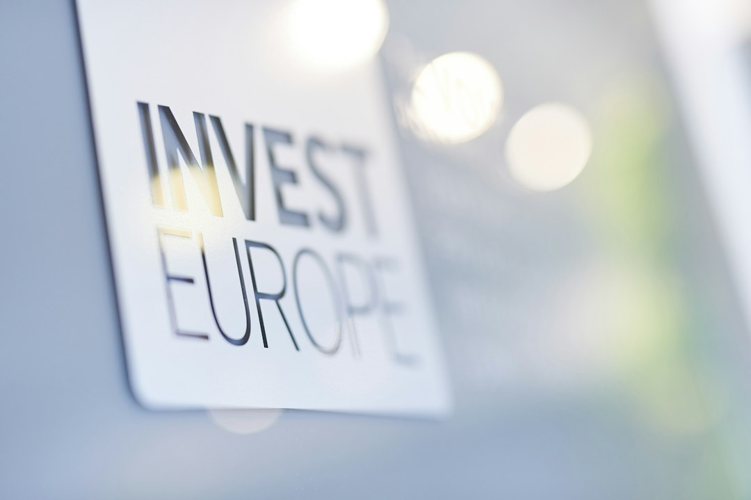 A sign displaying 'invest europe' with a blurred background