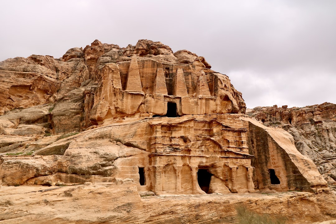 brown rock formation under white sky during daytime
