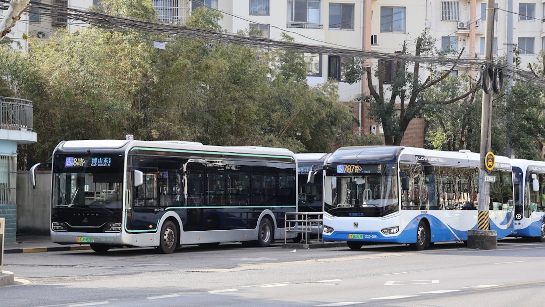 Two modern buses parked at a station.