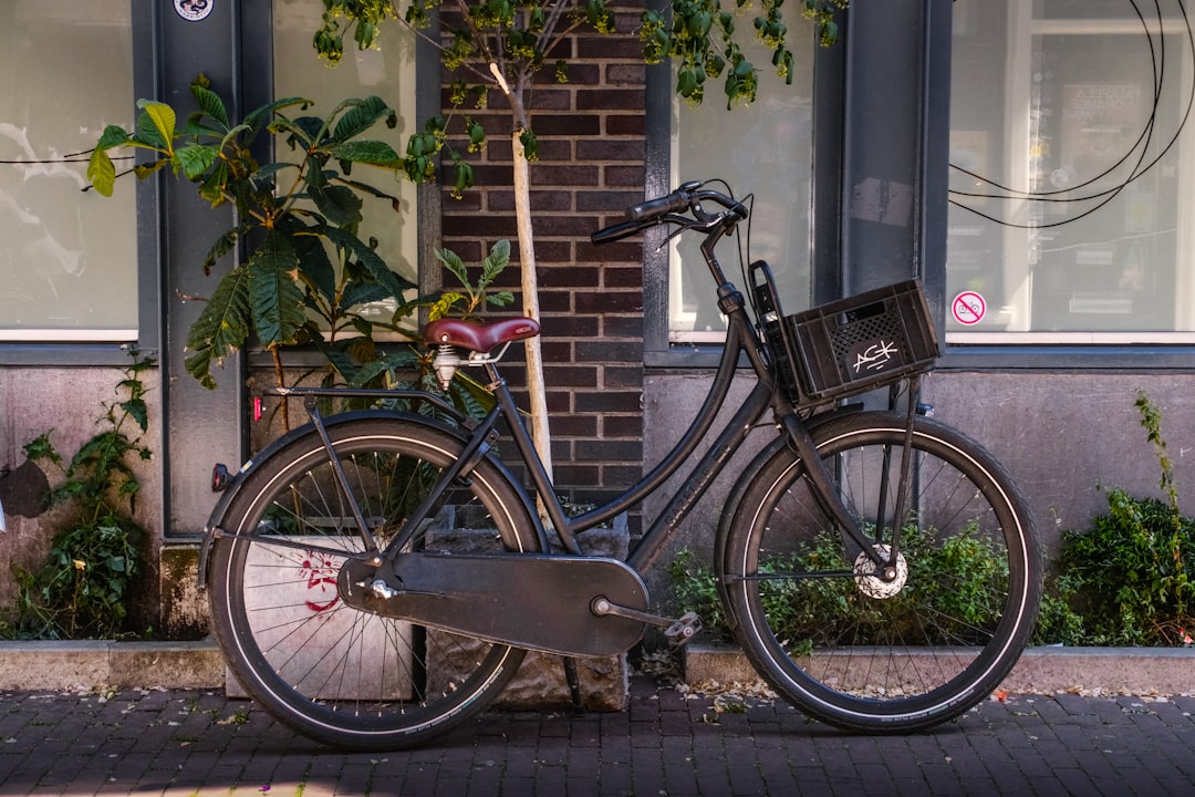 A black bicycle parked outside a building