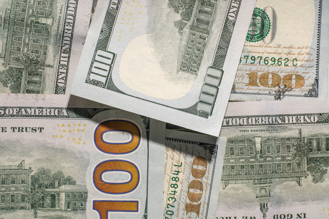 Us one hundred dollar bills are scattered.