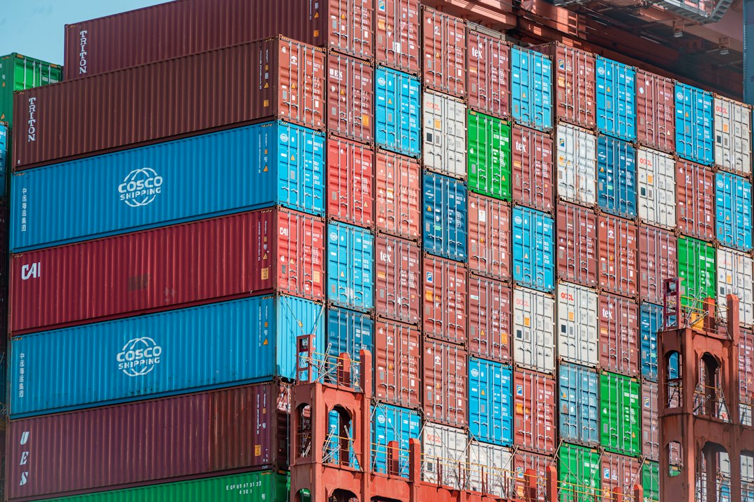 Numerous colorful shipping containers stacked high at a port