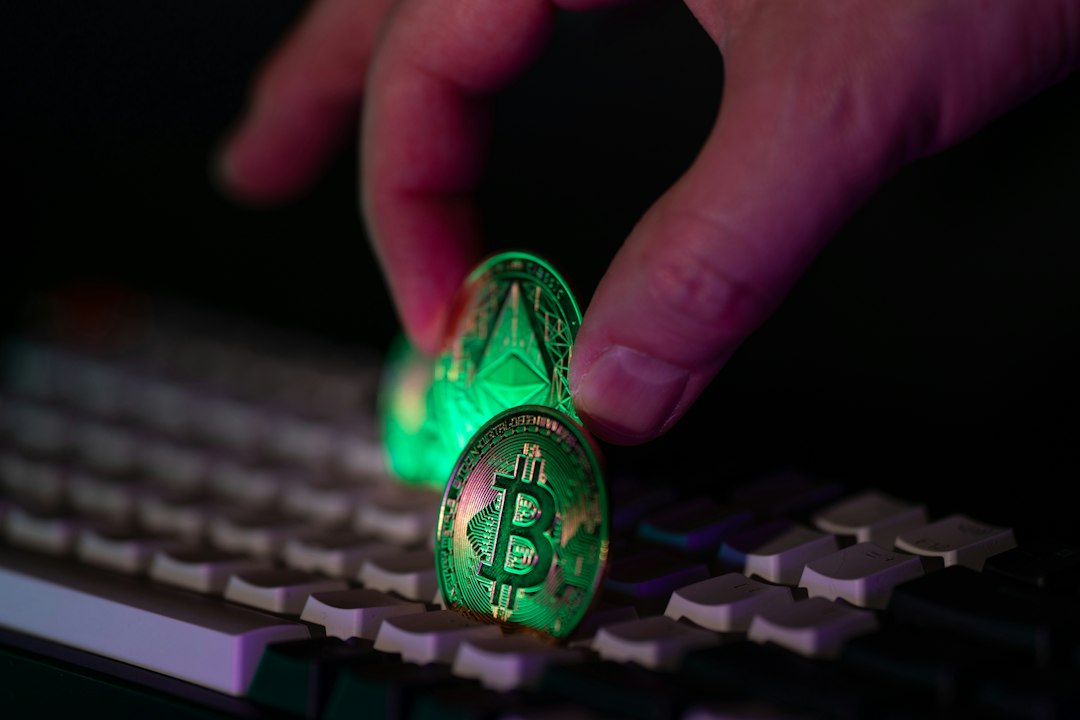 Hand placing glowing crypto coins on a keyboard