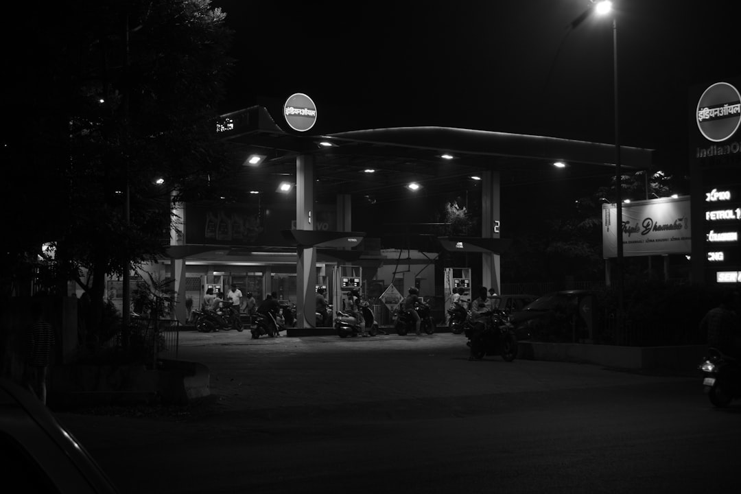 A black and white photo of a gas station at night