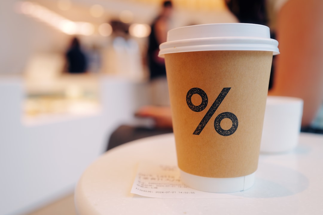 A cup of coffee sitting on top of a white table