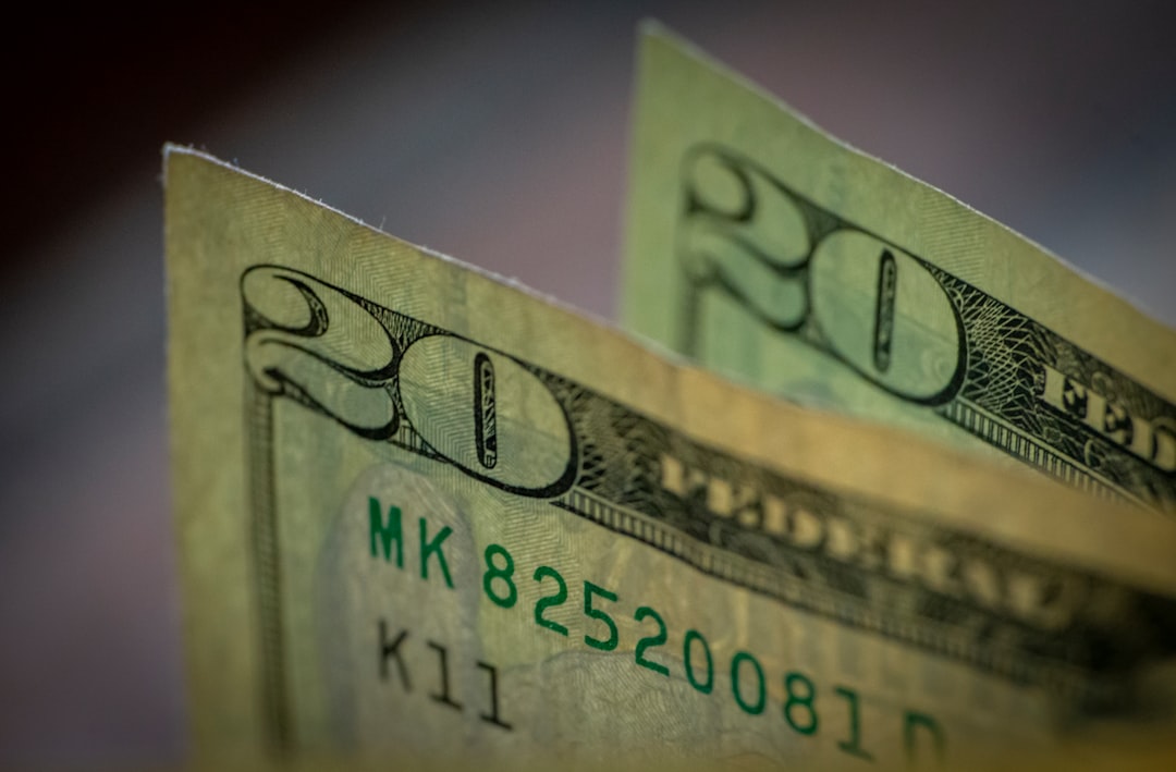 two stacks of twenty dollar bills sitting on top of each other