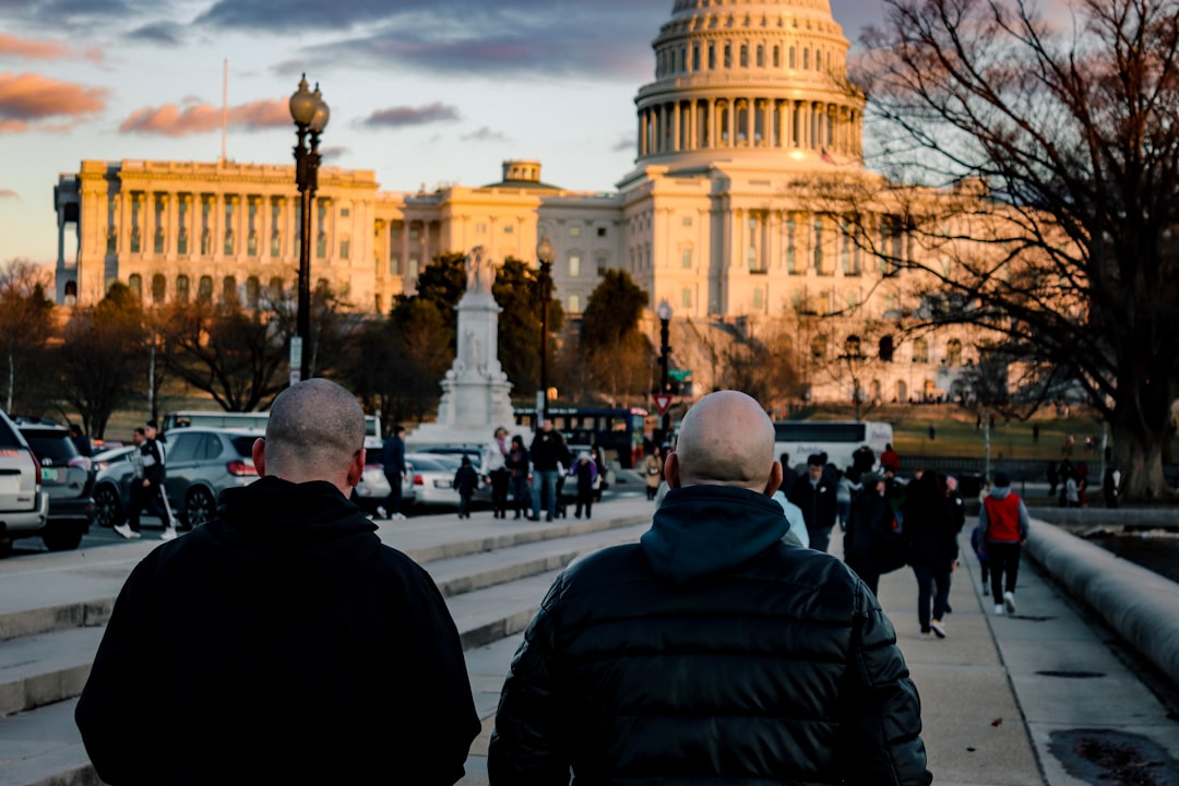 people walking towards beige building