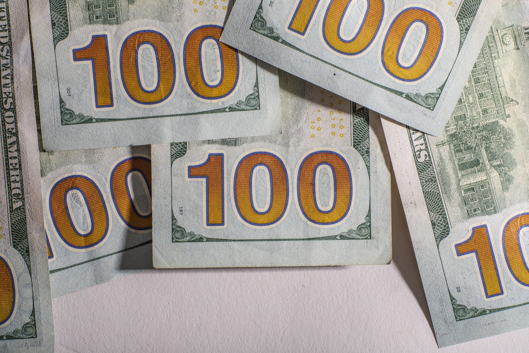 Several us hundred dollar bills are scattered.