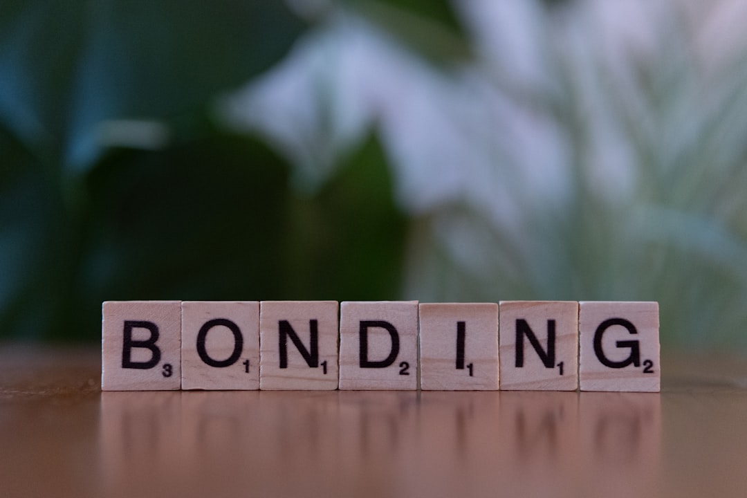 A wooden block spelling the word bonding on a table